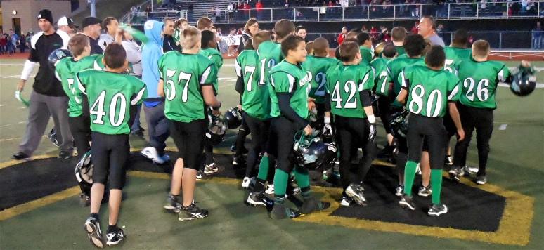 Knights players and coaches rally around Coach Joe
moments after winning the 2011 Super Bowl game.