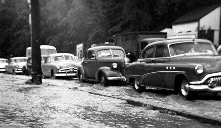 Cars drive through flood waters along Saw Mill Run Boulevard in 1956.
