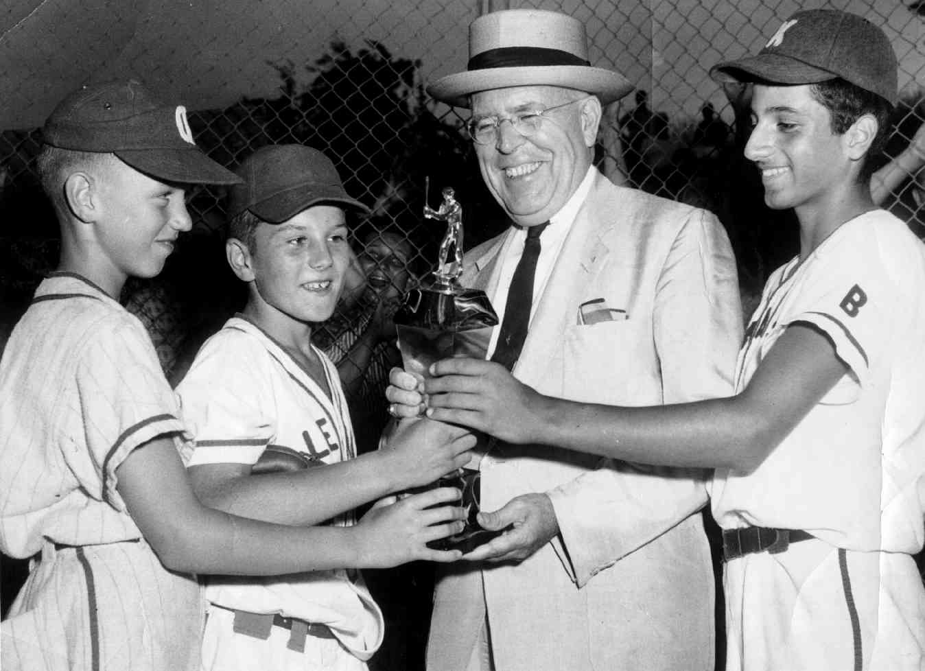 Mayor David Lawrence celebrates Brookline's victory
in the District 5 championship game of the Little League
World Series in 1958. Pictured with the mayor are Jack
Flavin, Jack Wertz and Fred Luvara