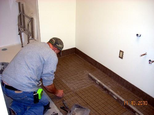 Laying the floor tile in the new bathroom.
